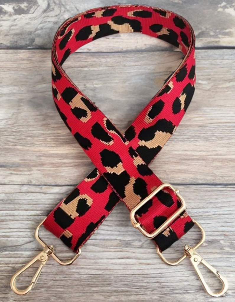 A picure of a red and black guitar strap for handbags. 